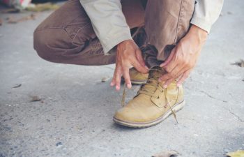 man tying shoes