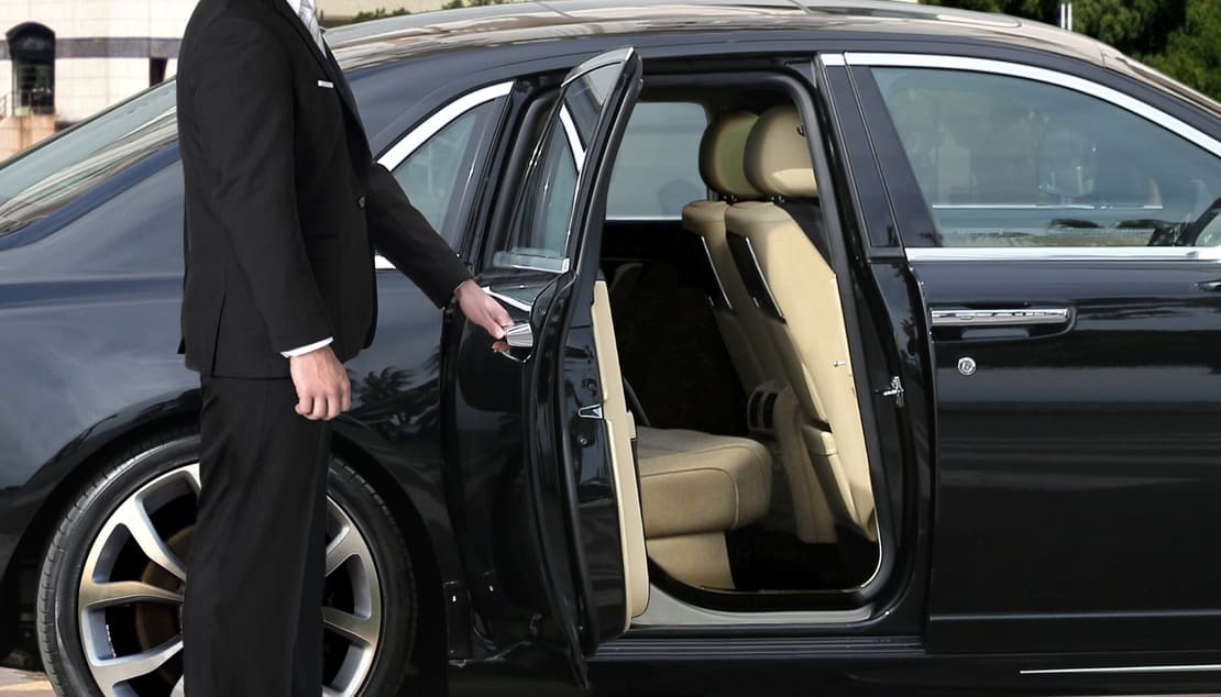 Chauffeur Opening Luxury Car
